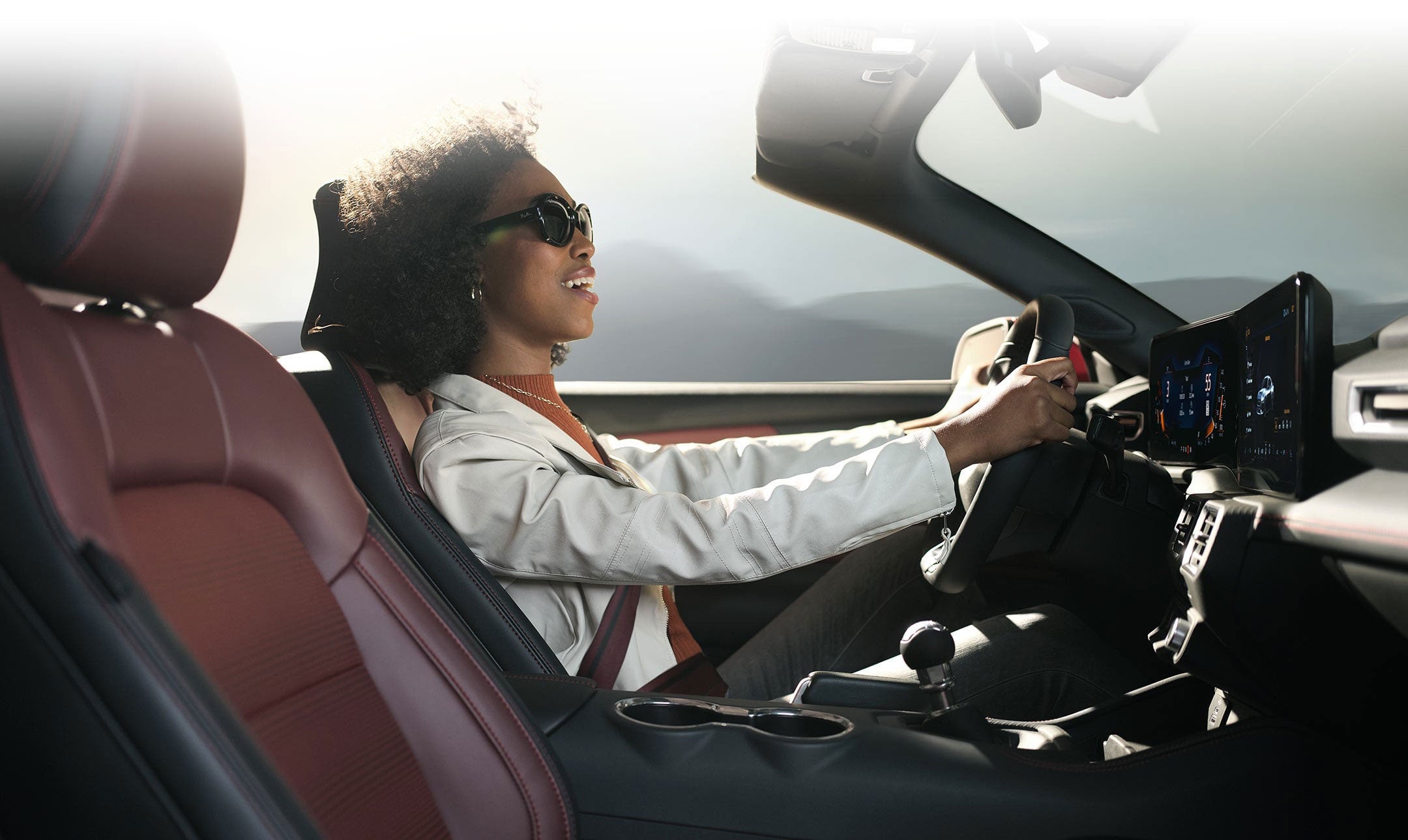 Person sitting in the driver’s seat of a 2024 Ford Mustang® convertible | Five Star Ford in Aberdeen WA