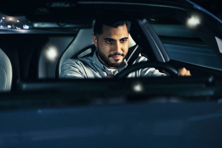 Person sitting in the driver’s seat of a parked 2024 Ford Mustang® coupe | Five Star Ford in Aberdeen WA